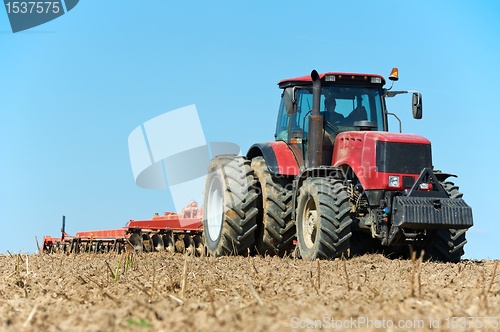 Image of Ploughing tractor at field cultivation work