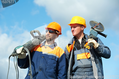 Image of construction workers with power tools