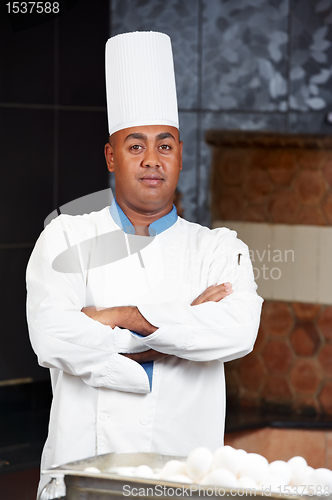 Image of chef in uniform at kitchen