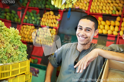 Image of arab youth invites to purchase fruits