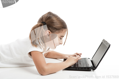 Image of Little student girl with a laptop
