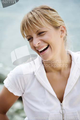 Image of smiling woman by the sea