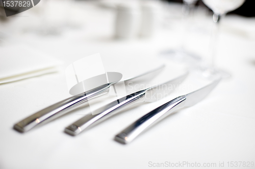 Image of knives at a table setting