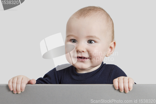 Image of young child holding sign