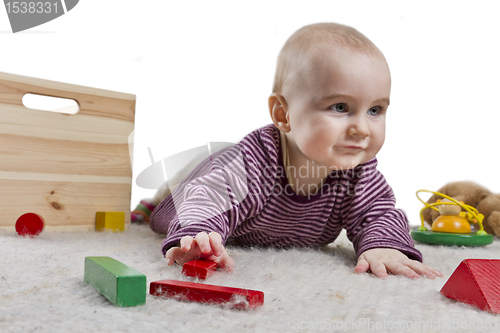 Image of baby playing on floor