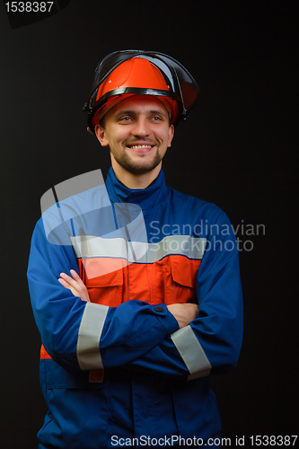 Image of The worker in overalls and a helmet