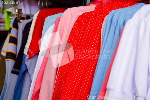 Image of Bright children's clothes on a hanger in the store