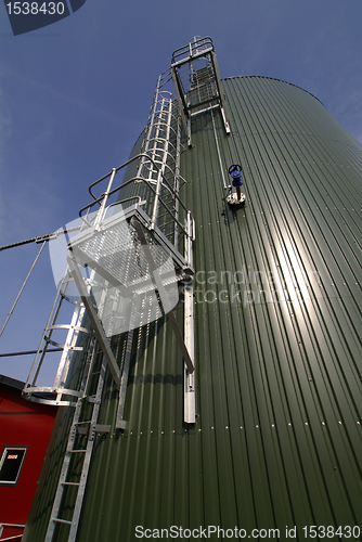 Image of Industrial zone, Steel pipelines and tanks against blue sky