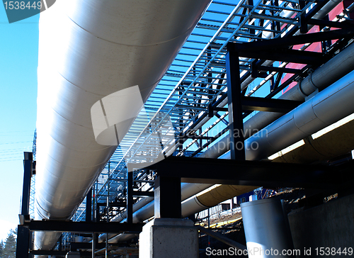 Image of Industrial zone, Steel pipelines and valves against blue sky