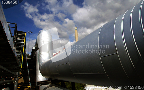 Image of Industrial zone, Steel pipelines and valves against blue sky