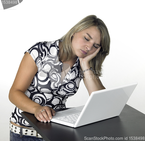 Image of blonde computing girl - sleepy