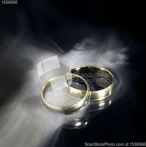 Image of golden wedding rings and smoke