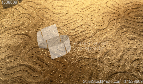 Image of abstract snake pattern in the sand