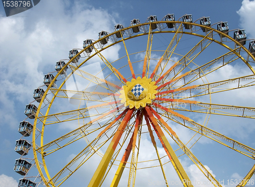 Image of big wheel and blue clouded sky