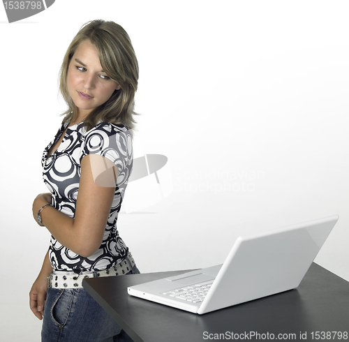 Image of young cute girl turns away from laptop