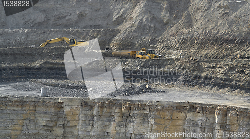 Image of quarry digger and dump trucks