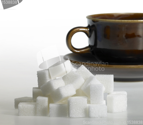 Image of lump sugar and brown coffee cup