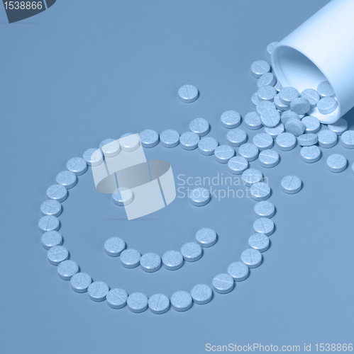 Image of blue pills forming a smiley