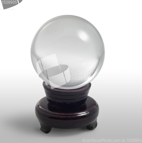 Image of crystal ball on stand in light back