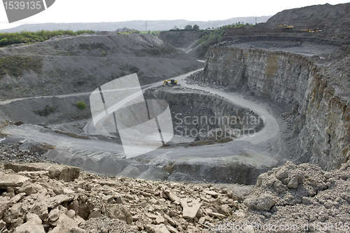 Image of quarry diggers and dump trucks