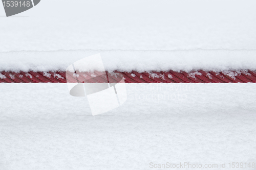 Image of snowcapped red rope