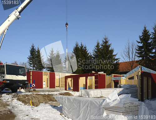 Image of wooden house construction in sunny ambiance