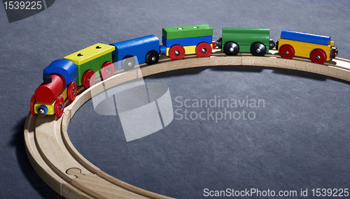 Image of colorful wooden toy train on tracks