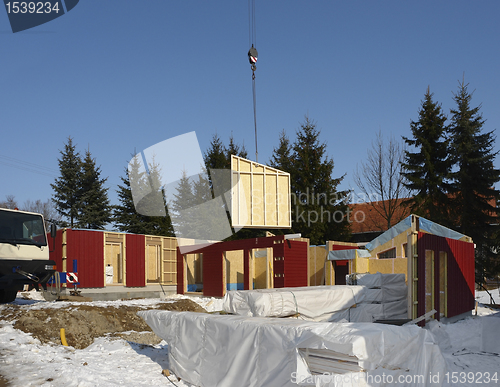 Image of wooden house construction in sunny ambiance