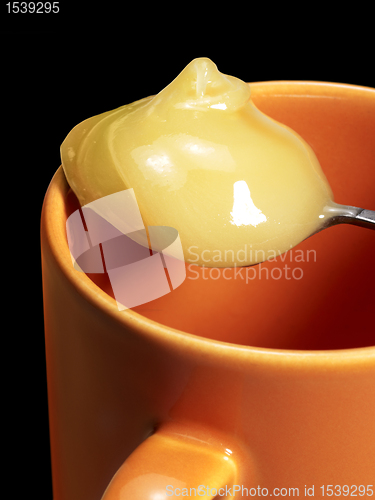 Image of cup and honey spoon