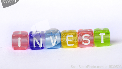 Image of Text Invest on colorful wooden cubes 