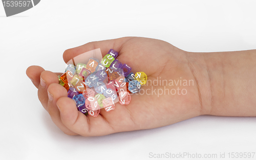 Image of Children hand holding cubes with letters