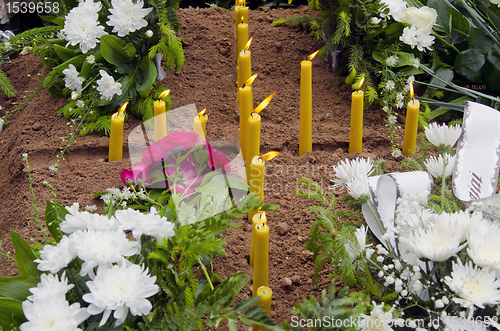 Image of Candles on the grave.