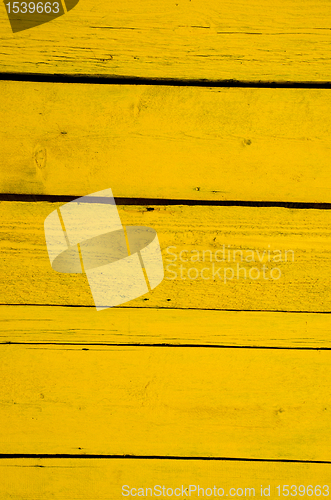 Image of Wall made of yellow wooden planks. 