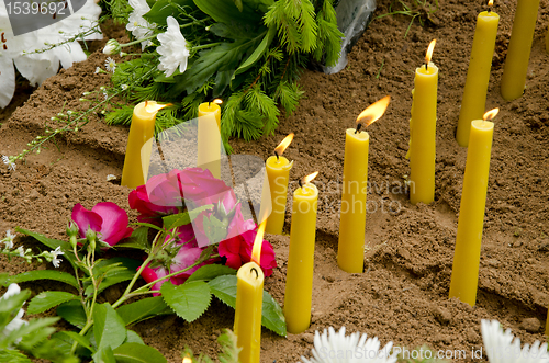 Image of Candles on the grave.