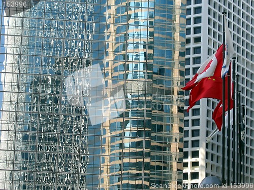 Image of Flags reflecting in skyscraper windows