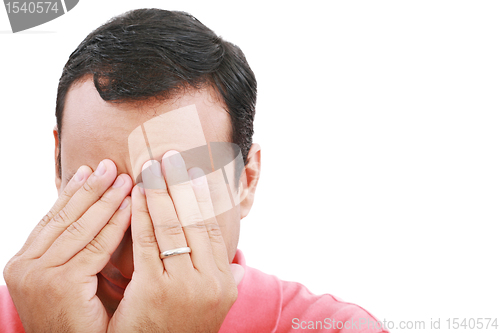 Image of Man frustrated with hands on his face. 