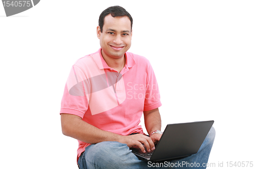 Image of Man sitting on the floor with a laptop - isolated over a white b
