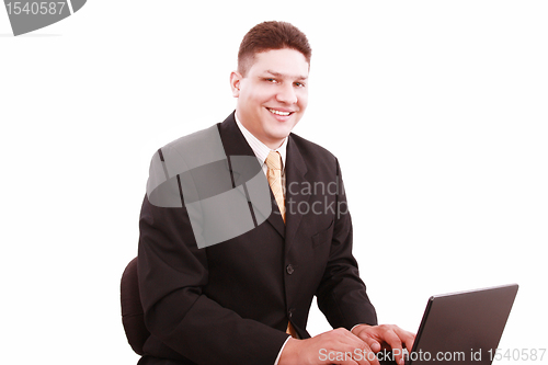 Image of Portrait of businessman in front of laptop computer 