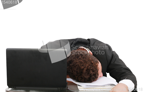 Image of young business man sleeping on the laptop 