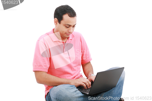Image of Young man sitting on the floor and work with laptop computer 