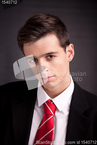 Image of Portrait of a young business man isolated on black background