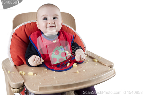 Image of toddler eating potatoes