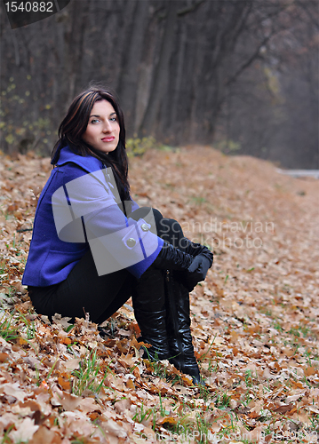 Image of Young woman in the autumn park