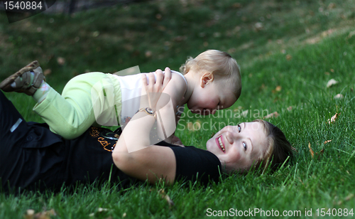 Image of Mother with sone play on a grass