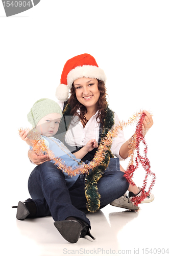 Image of Girl in a santa hat with a little  boy