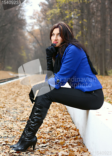 Image of Young woman in the autumn park