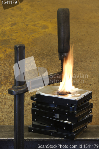 Image of burning vise and hard disks