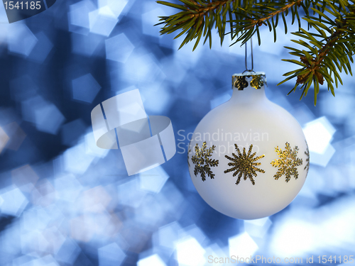 Image of white Christmas bauble in blue back