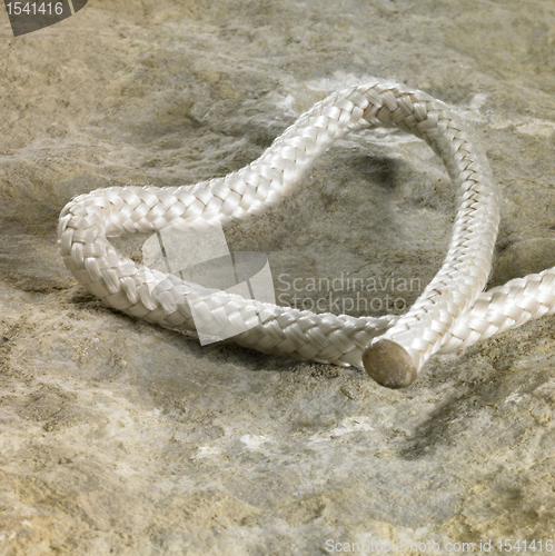 Image of rope end and stone