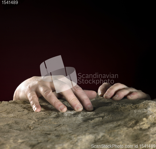Image of hands on stone surface